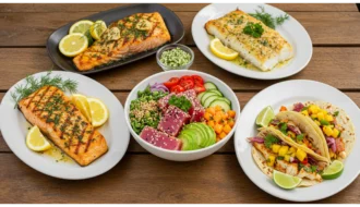A beautifully arranged table featuring grilled lemon herb salmon, baked garlic butter cod, spicy tuna poke bowl, and colorful fish tacos.