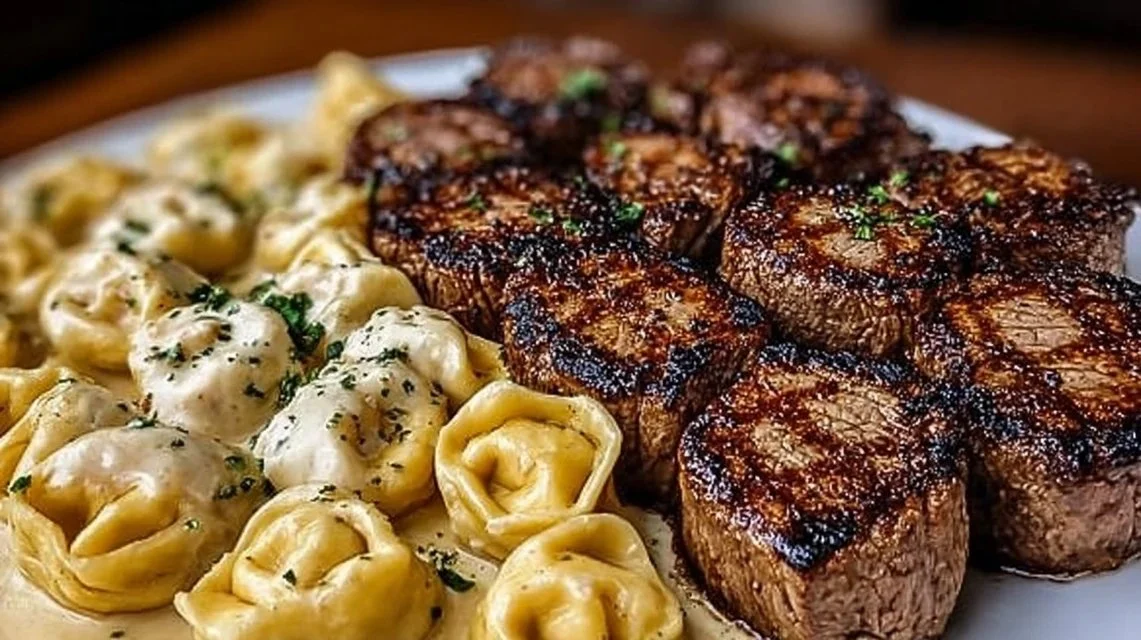 Garlic Butter Steak served with Cheesy Alfredo Tortellini on a plate