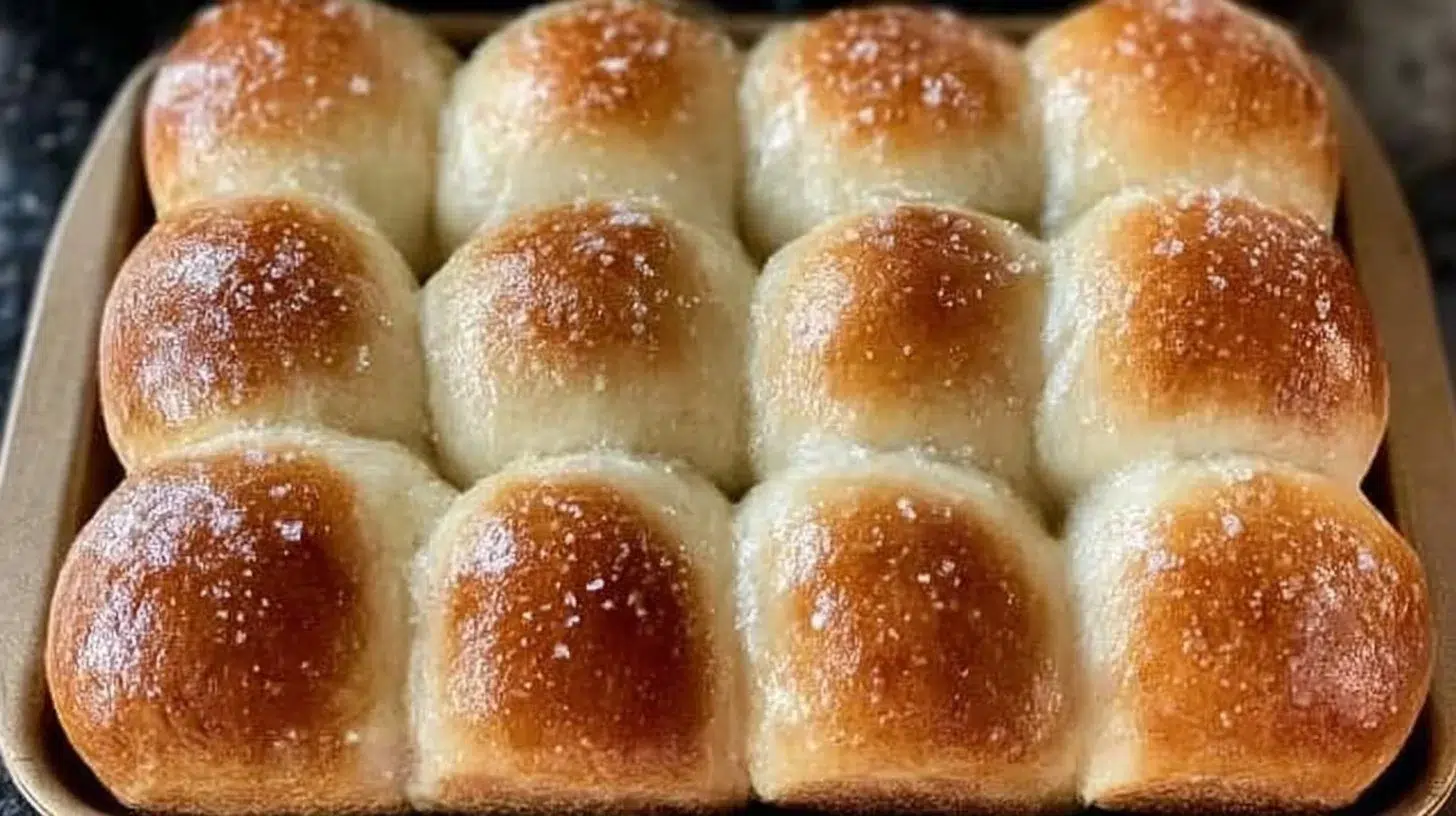 Freshly baked one hour sourdough discard rolls on a wooden table.