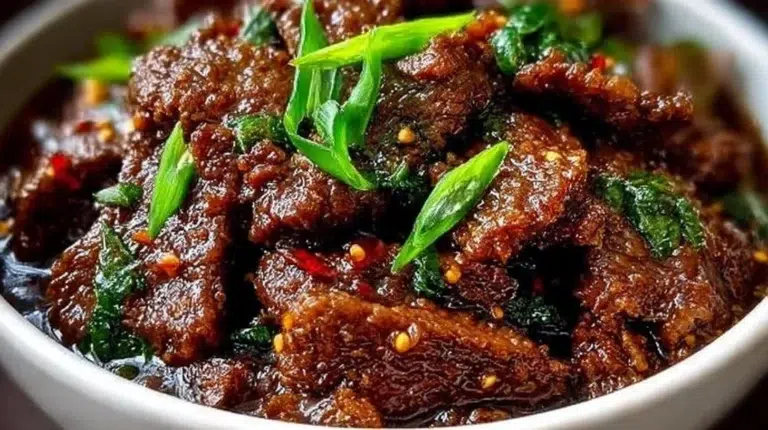 Delicious Slow Cooker Mongolian Beef served with rice and vegetables