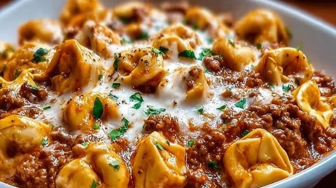 Delicious Beefy Tortellini Bake topped with melted cheese and herbs.