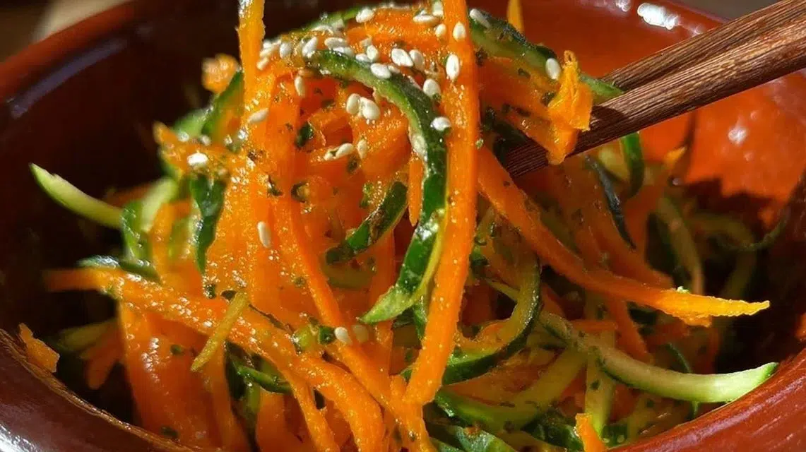 Fresh cucumber carrot salad with colorful vegetables in a bowl