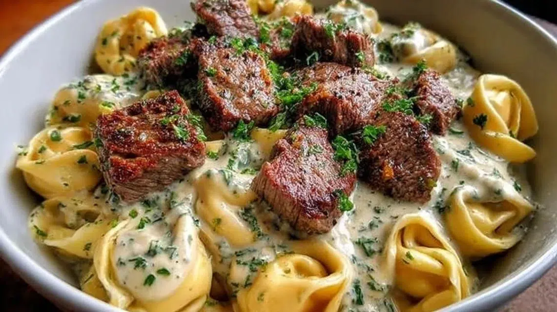 Garlic Steak Tortellini Skillet served in a skillet with fresh herbs