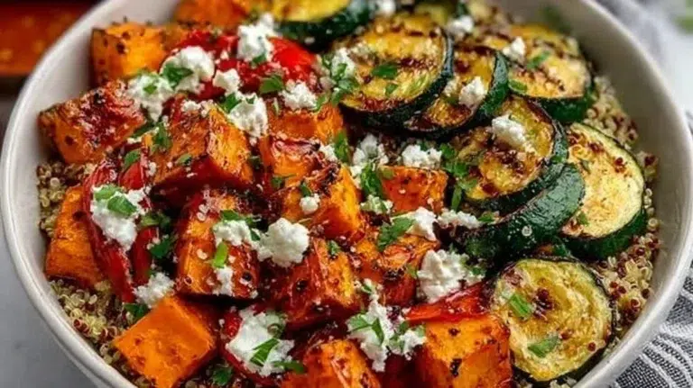 Healthy roasted vegetable quinoa bowl topped with fresh ingredients
