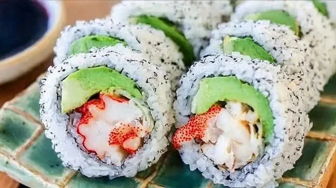 California Roll sushi featuring fresh avocado, crab, and sushi rice rolls.