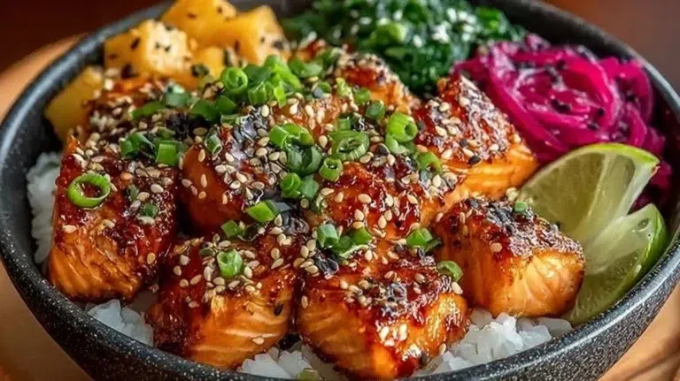 Crispy salmon and rice bowl topped with fresh vegetables and sauce