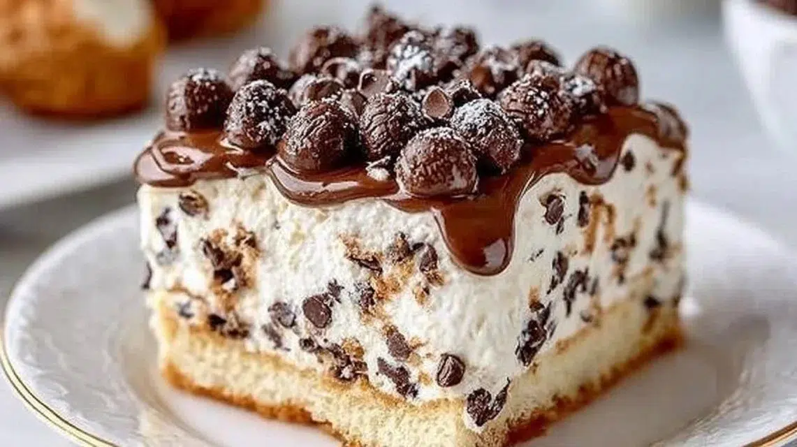 Easy Cannoli Cake topped with creamy filling and chocolate chips
