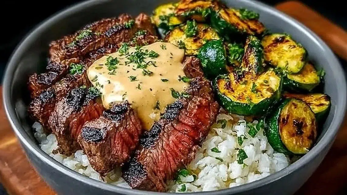Delicious grilled steak bowl with sauce and grilled zucchini on a plate