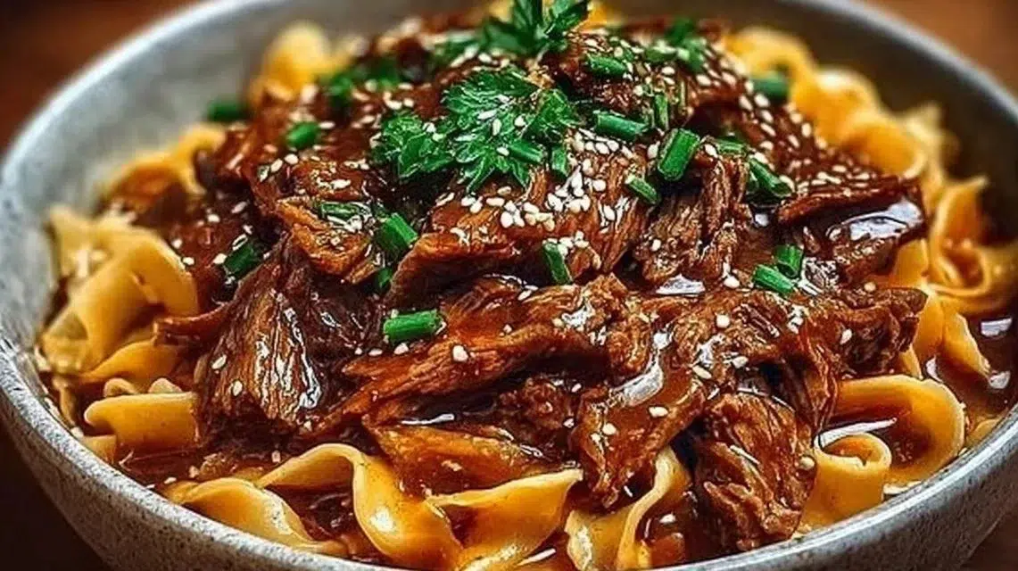 Bowl of Korean beef noodles with tender beef, vegetables, and broth