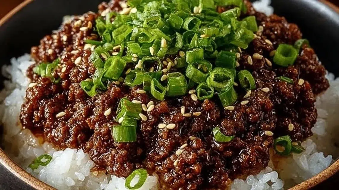 Korean Ground Beef Bowl topped with fresh vegetables and sesame seeds