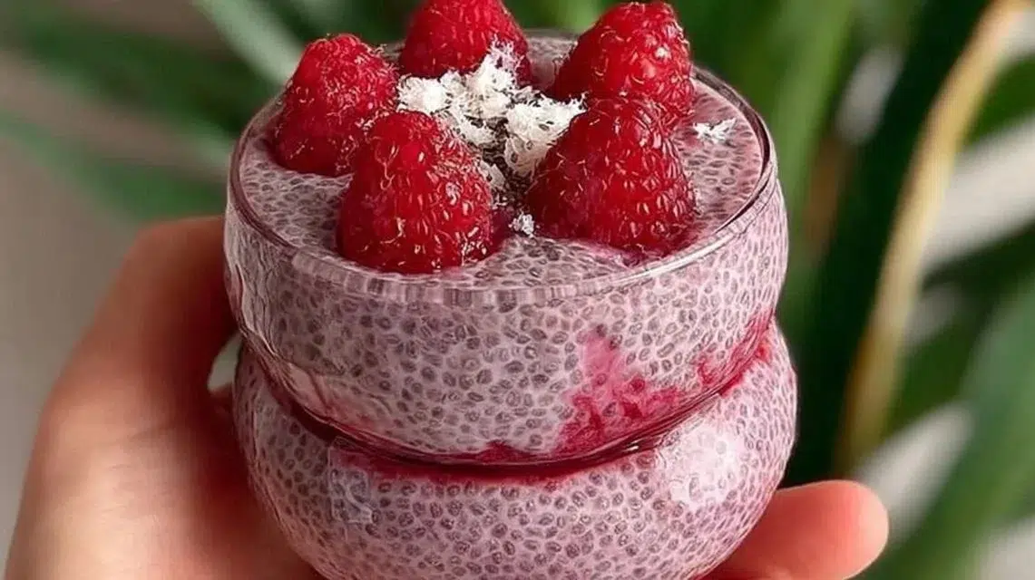 Delicious Raspberry Chia Pudding served in a glass with fresh raspberries on top