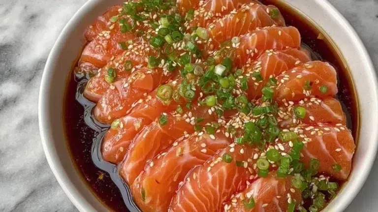 Soy citrus salmon sashimi displaying fresh slices of salmon with a citrus glaze.