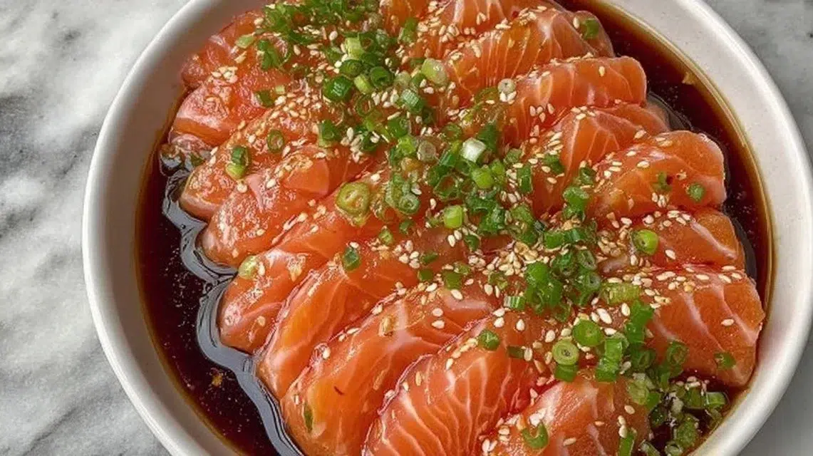 Soy citrus salmon sashimi displaying fresh slices of salmon with a citrus glaze.