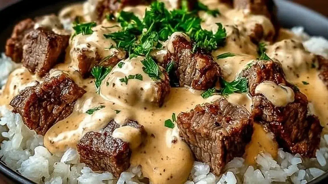 Delicious Steak Cheese Rice Bowl topped with fresh ingredients and cheese