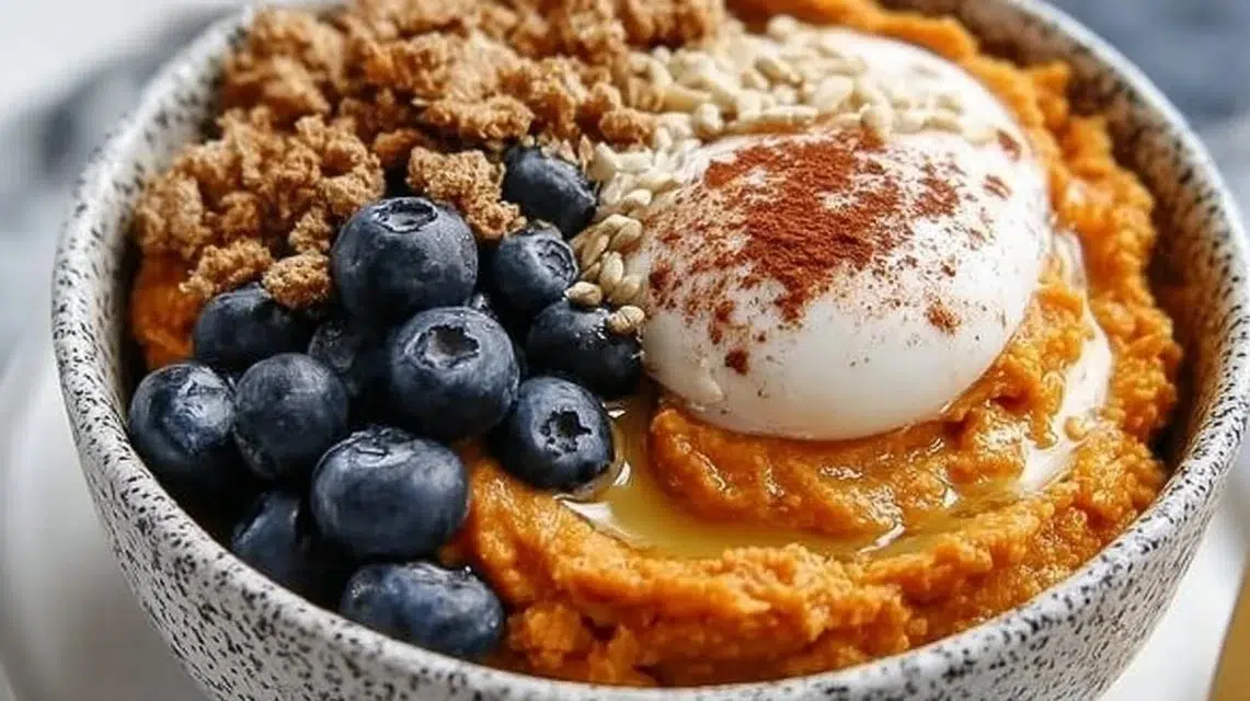 Colorful sweet potato breakfast bowls topped with fruits and nuts