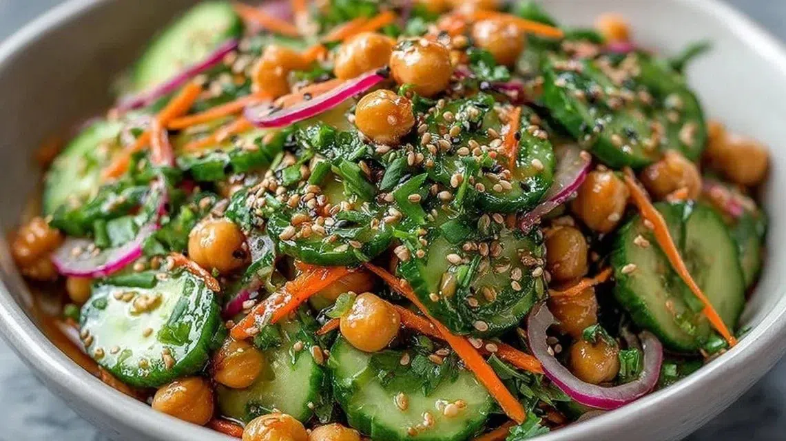 Asian cucumber and chickpea slaw with sesame dressing in a bowl