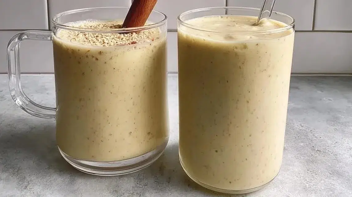 Banana date protein shake in a glass with ingredients on the side