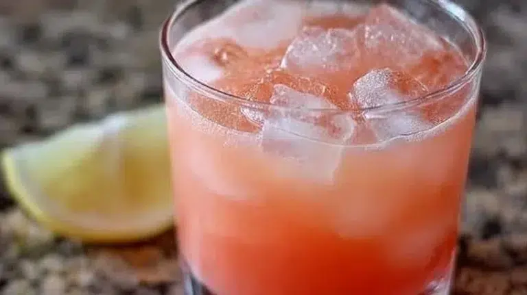 Iced Guava White Tea Lemonade in a glass with a tropical garnish