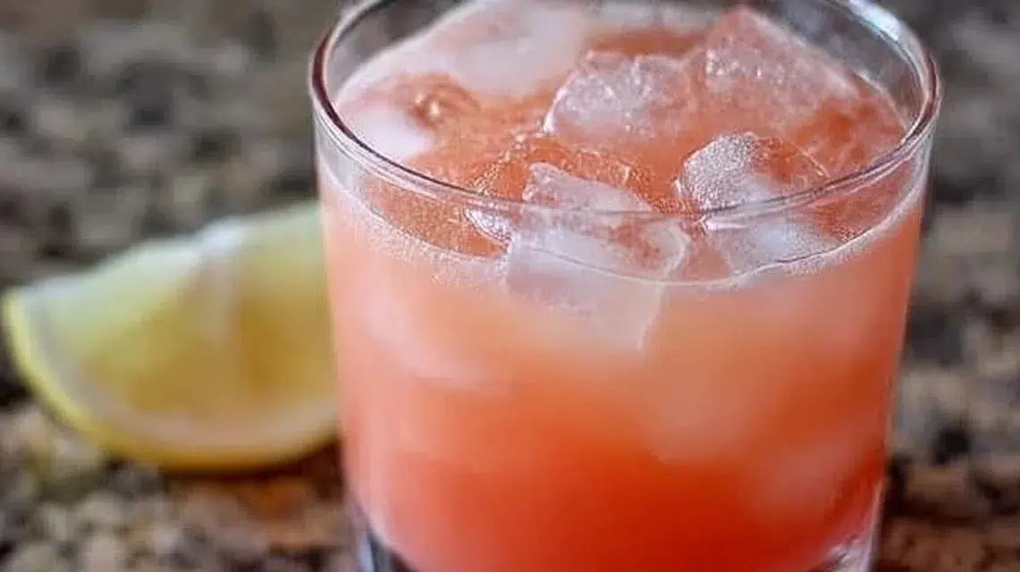 Iced Guava White Tea Lemonade in a glass with a tropical garnish