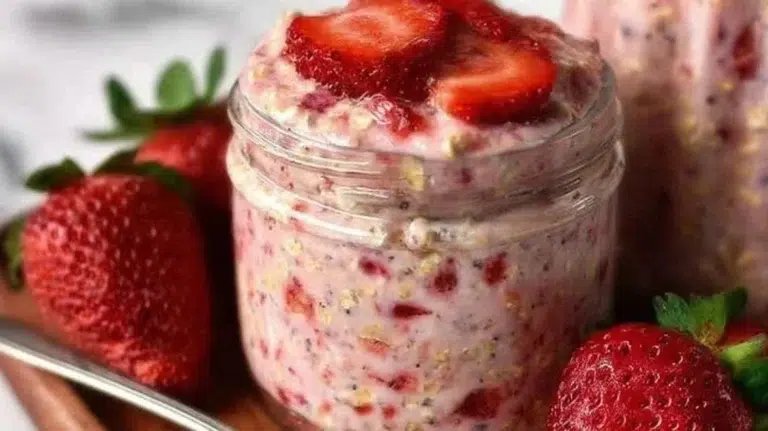 Delicious bowl of strawberries and cream overnight oats topped with fresh strawberries