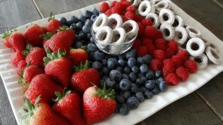 Colorful 4th of July fruit platter with strawberries, blueberries, and watermelon.