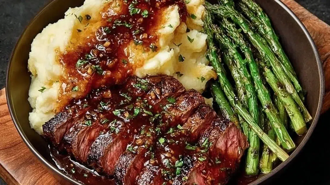 Bavette steak served with roasted garlic pan sauce on a plate