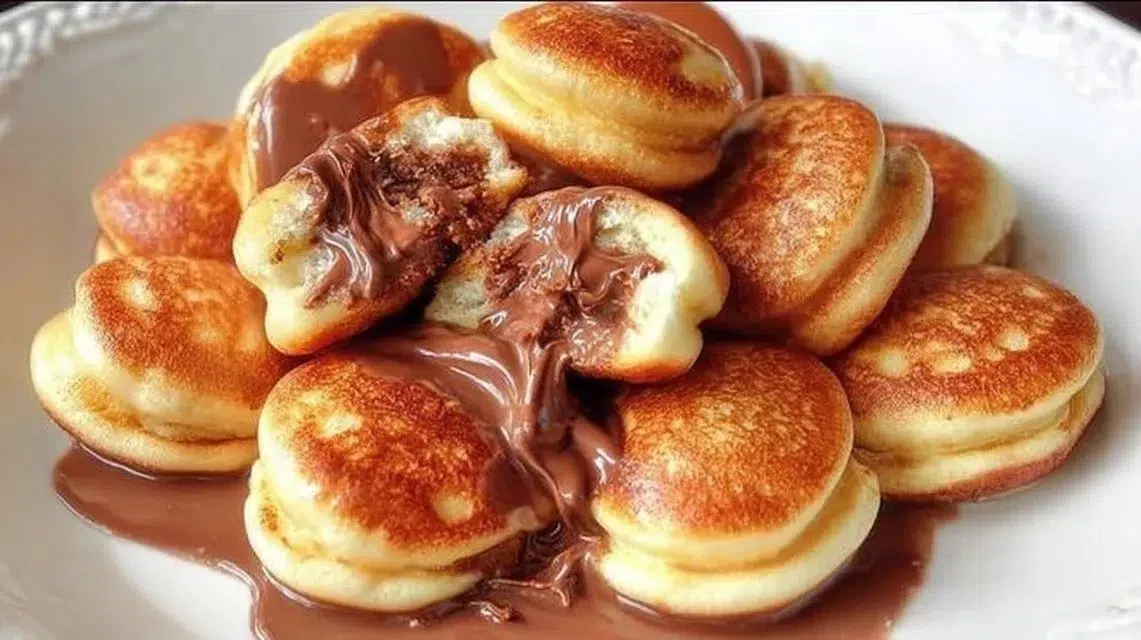 Delicious fluffy pancakes stacked high with syrup and berries.