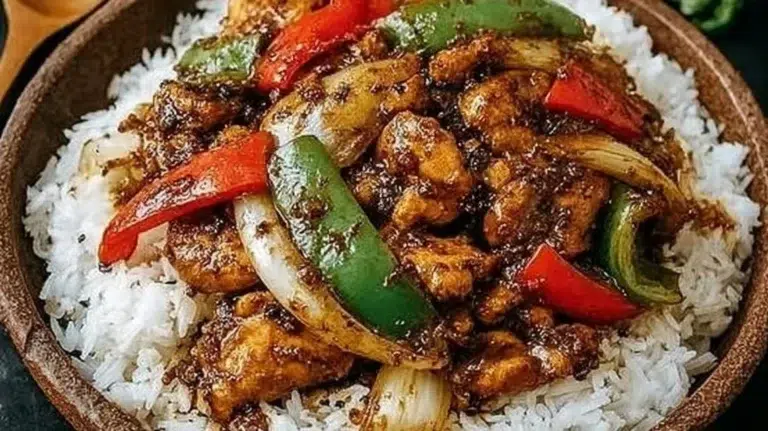 Delicious black pepper chicken dish garnished with fresh herbs