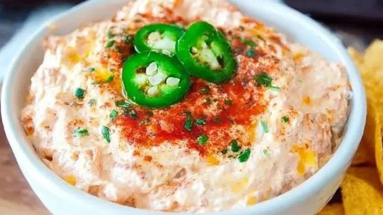 Delicious Cream Cheese Rotel Dip served in a bowl with tortilla chips on the side.