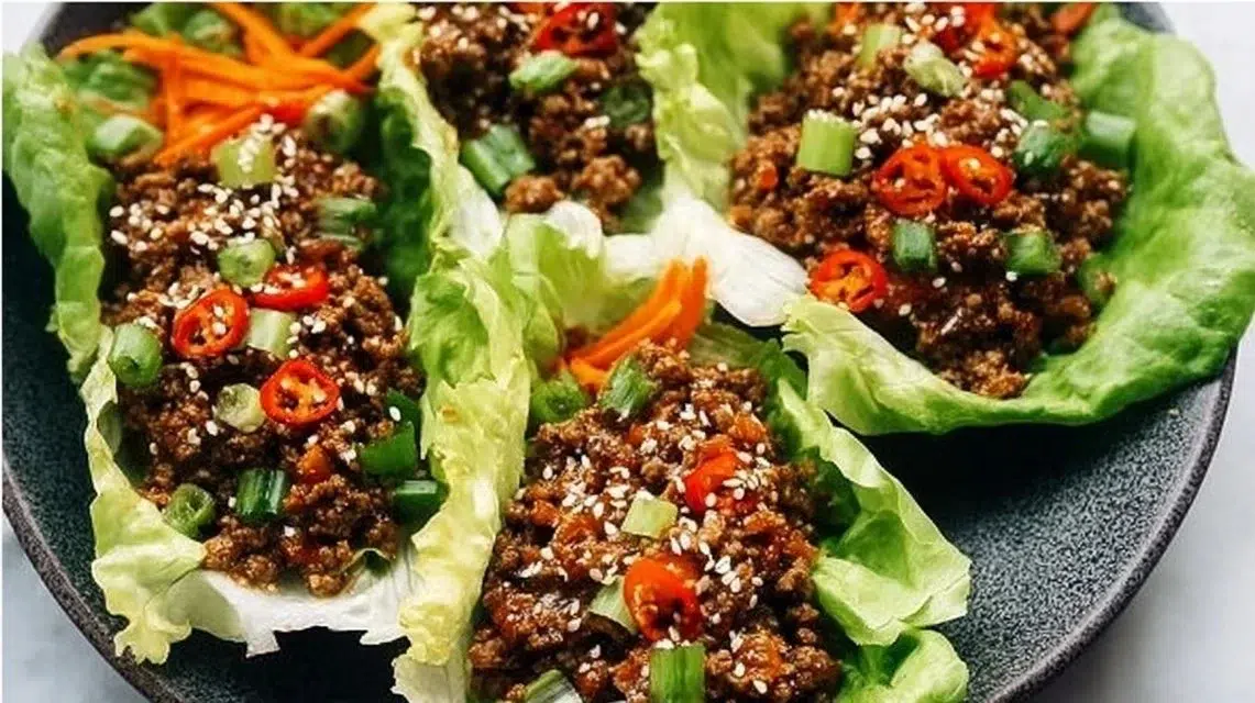 Ground beef lettuce wraps served with fresh vegetables and sauce