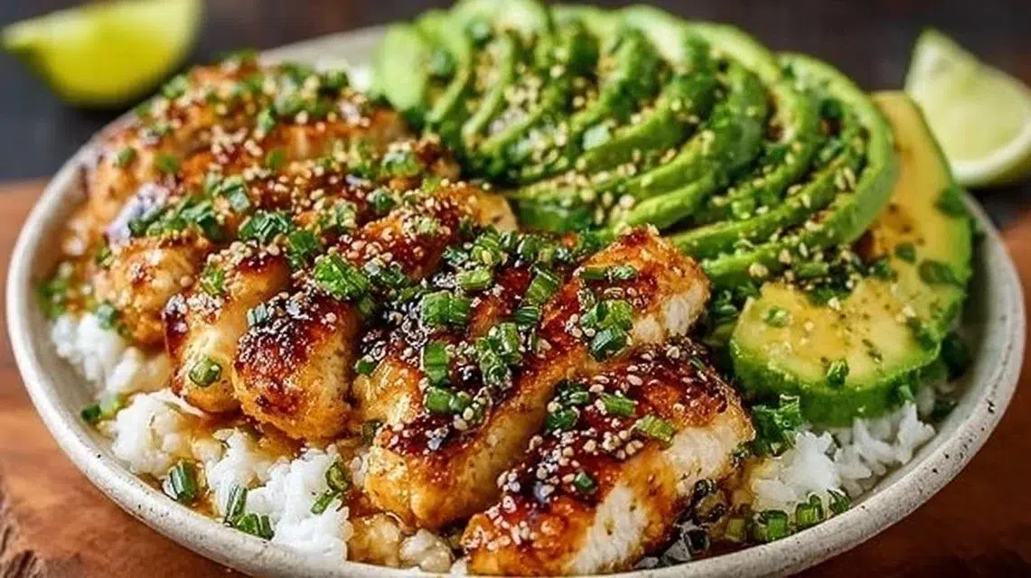 Plate of Honey Lime Chicken with avocado slices and fresh herbs