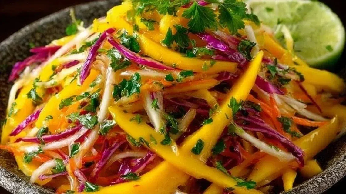 A bowl of colorful Mango Slaw with mango, cabbage, and dressing