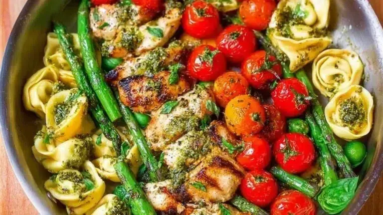 One-Pan Pesto Chicken with tortellini and vegetables in a skillet dish
