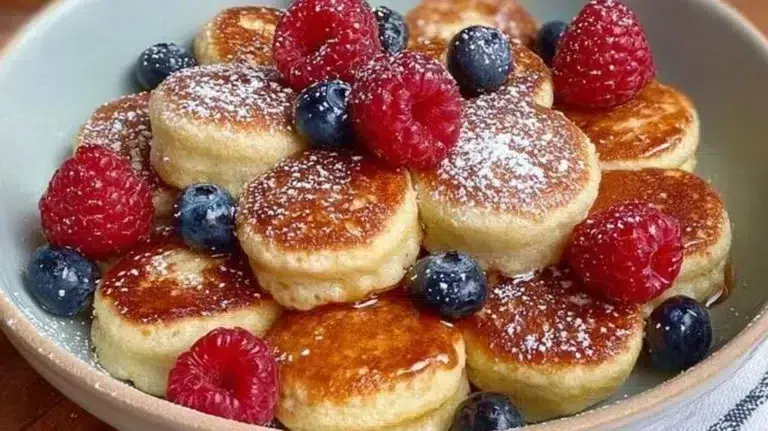 Pancake mini muffins served on a plate with maple syrup drizzle