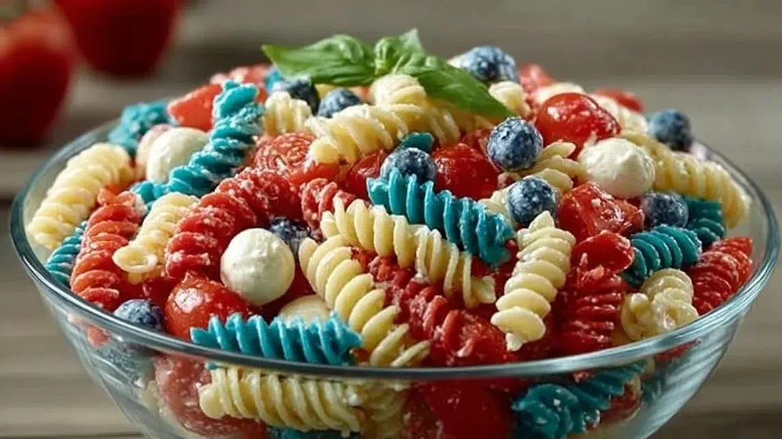 A colorful Red White and Blue Pasta Salad served in a bowl, perfect for summer celebrations.