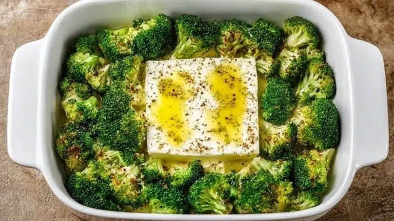 Baked feta pasta with broccoli in a creamy sauce served on a plate.