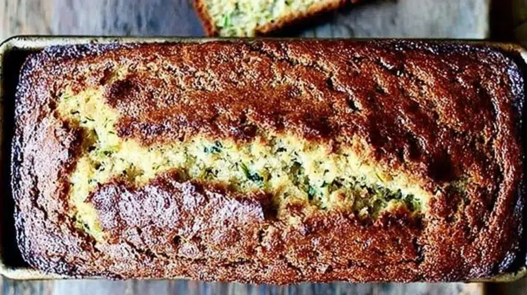 Delicious slice of moist zucchini bread on a wooden table