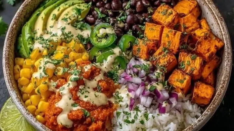 Plant-based burrito bowl topped with roasted sweet potatoes and fresh ingredients