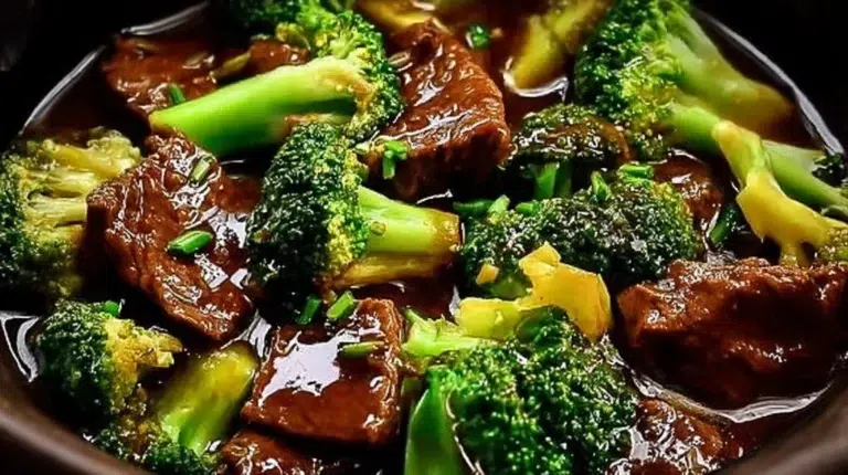 Slow Cooker Beef and Broccoli served on a plate with rice and vegetables