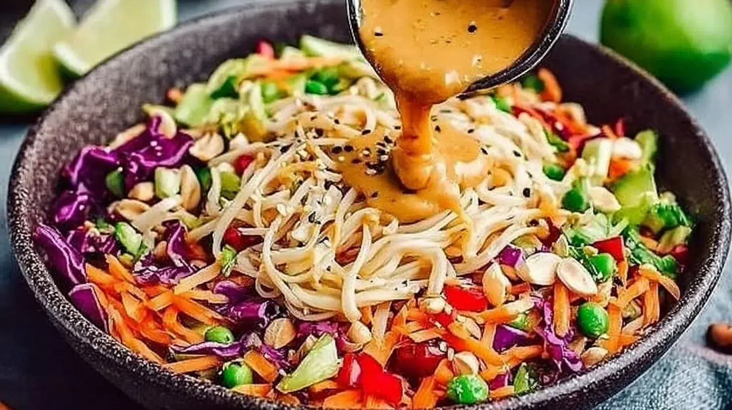 Thai Peanut Noodle Salad topped with creamy peanut sauce and fresh vegetables