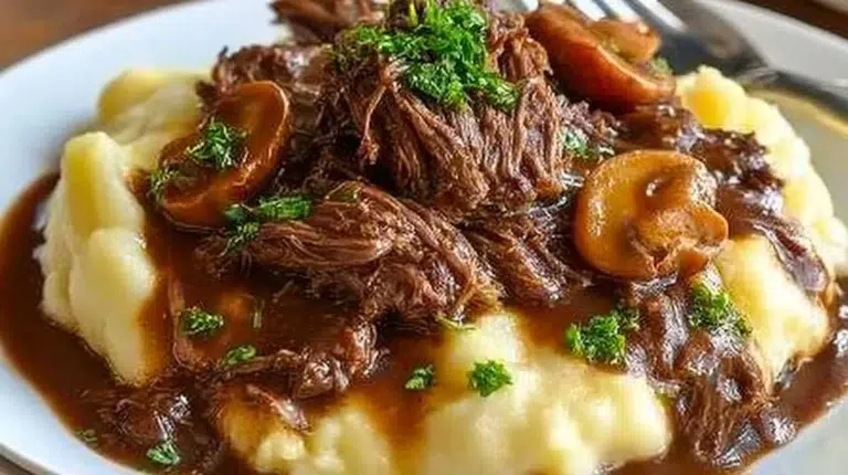 Slow Cooker Beef Manhattan dish served with mashed potatoes and gravy