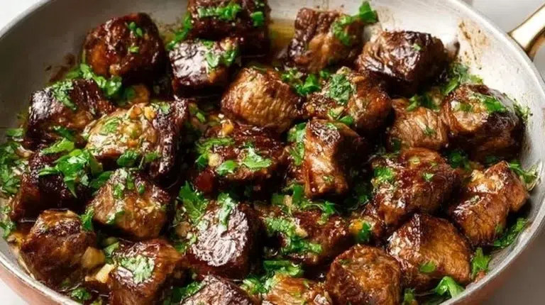 Garlic Butter Steak Bites served with fresh herbs and a side of veggies